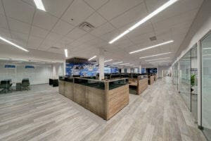 An image of an industrial open office with grey wood flooring