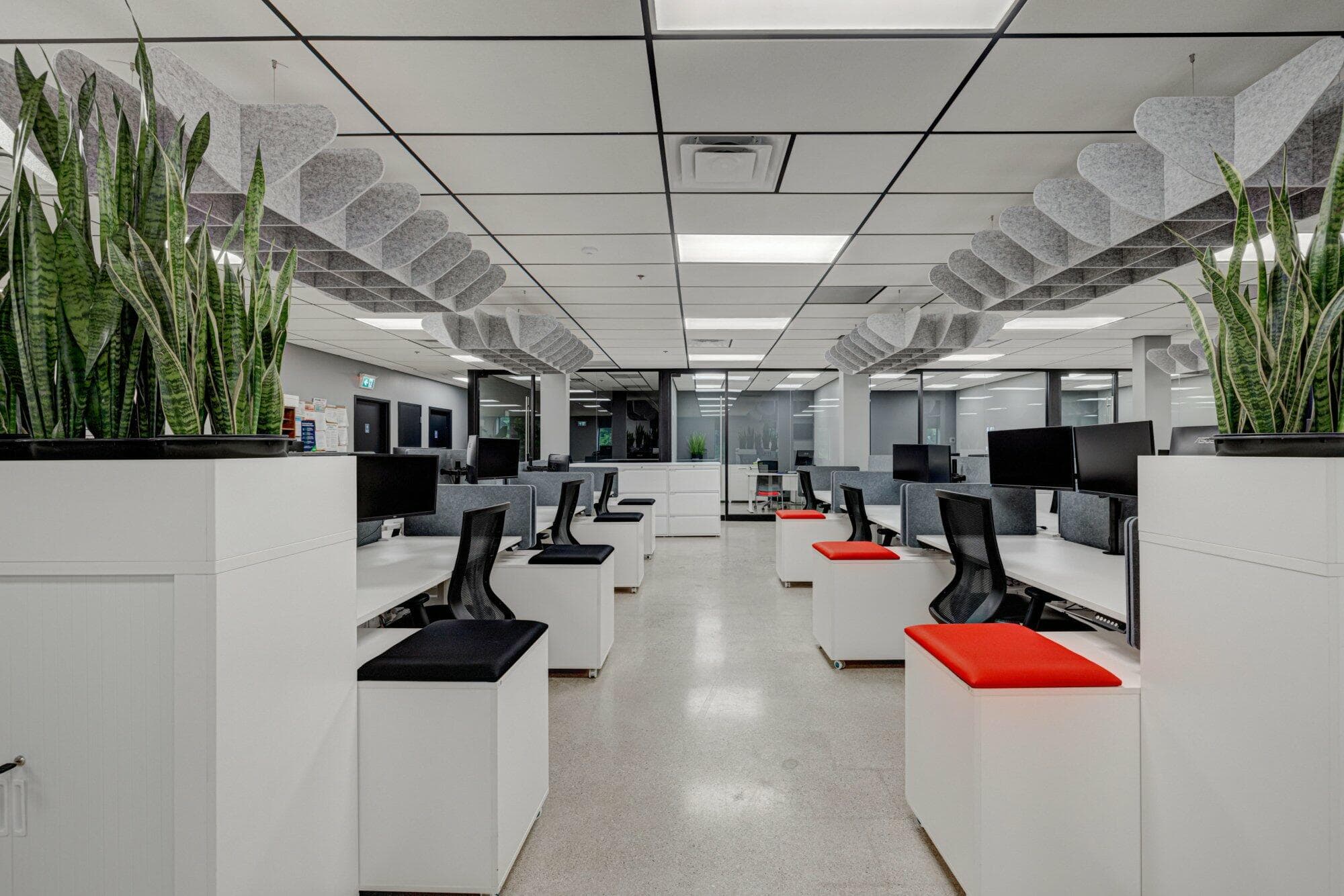 Receding row of office desks, chairs, and storage units