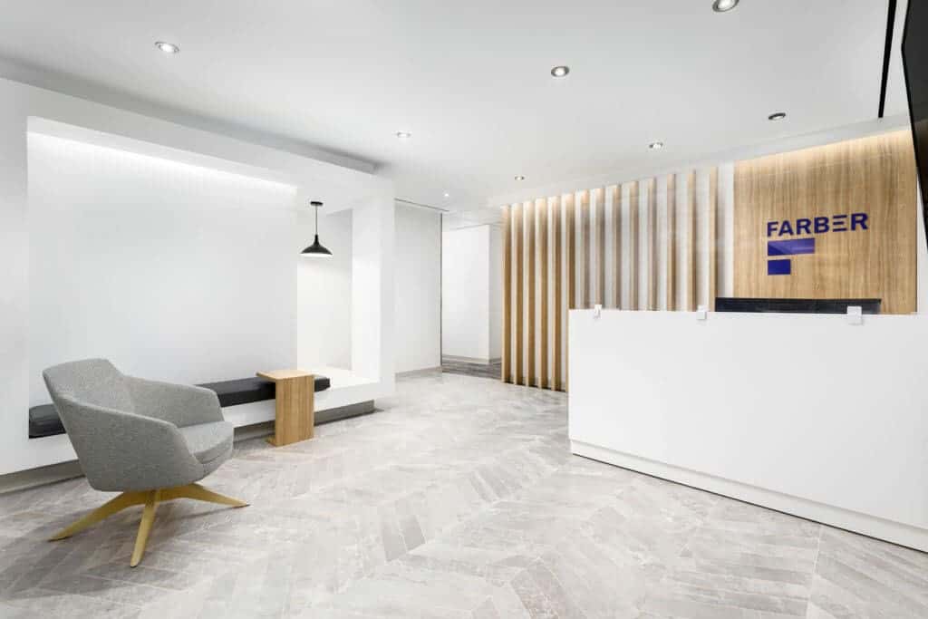 Modern business lobby with light wood slatting and white reception desk