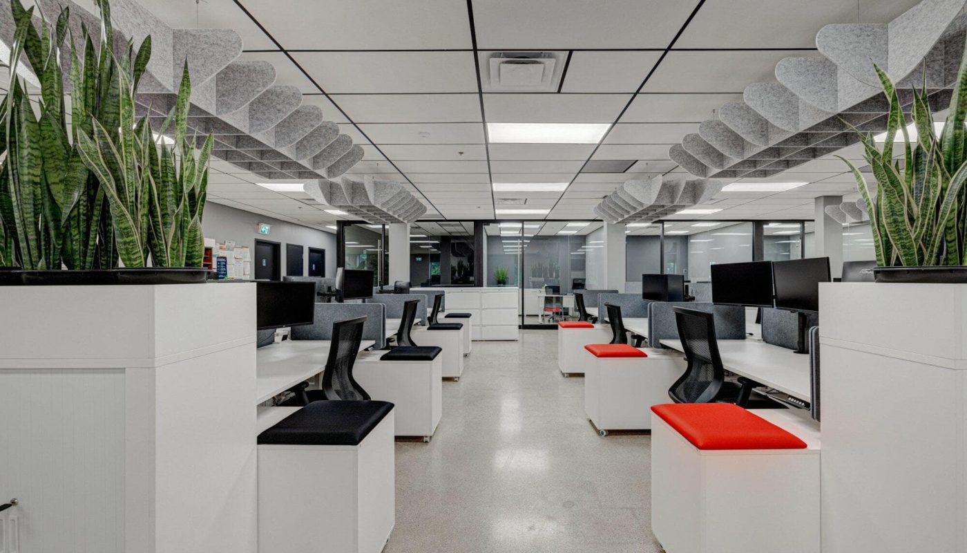 Receding row of office desks, chairs, and storage units