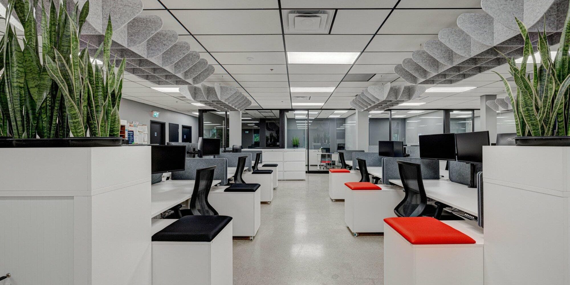 Receding row of office desks, chairs, and storage units